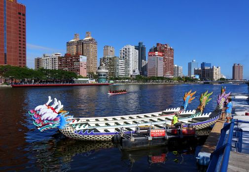 KAOHSIUNG, TAIWAN -- MAY 27, 2016: Workers transport barges on the Love River in preparation for the upcoming Dragon Boat Festival.