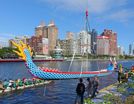 KAOHSIUNG, TAIWAN -- MAY 27, 2016: A crane lowers a dragon boat into the Love River in preparation for the upcoming Dragon Boat Festival.