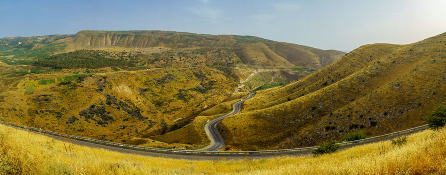 Panoramic landscape of the Golan Heights, winding road 98, and the Yarmouk River valley, near the border between Israel and Jordan