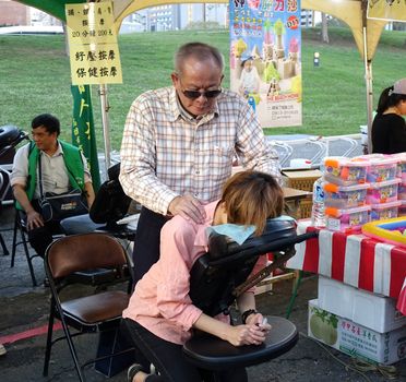 KAOHSIUNG, TAIWAN -- FEBRUARY 13, 2016: Vision impaired people offer massage services  during the 2016 Lantern Festival.
