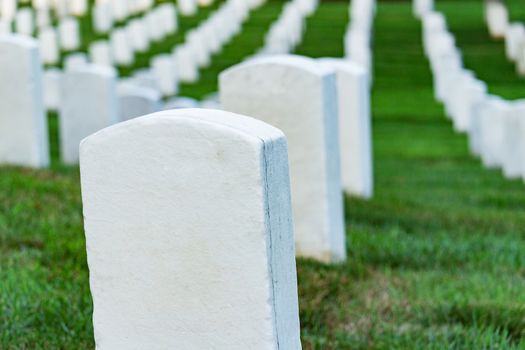 Grave stones on a peaceful cemetery, selective focus on a front stone.