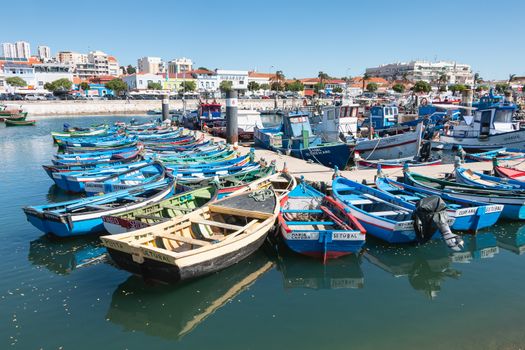 Setubal, Portugal - August 8, 2018: view of the small fishing port of Setubal with its typical blue boats on a summer day