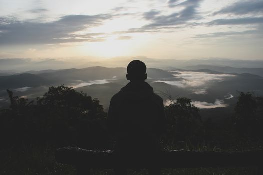 man is looking at the morning mist. At the Doi Samoe Dao National Park, NAN, Thailand