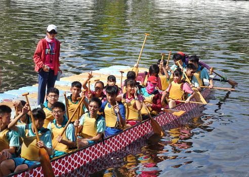 KAOHSIUNG, TAIWAN -- JUNE 10, 2018: A team of junior high school students prepares for the upcoming Dragon Boat Races.
