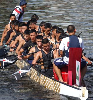 KAOHSIUNG, TAIWAN -- JUNE 10, 2018: A team of sailors from the navy prepares for the upcoming Dragon Boat Races.