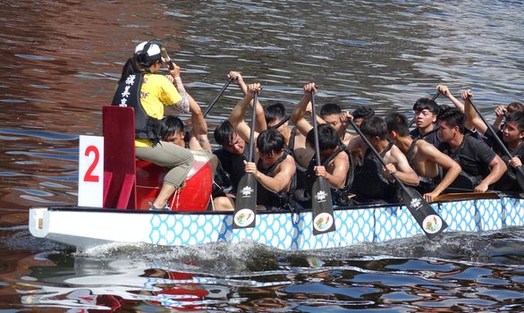 KAOHSIUNG, TAIWAN -- JUNE 10, 2018: A team of students trains for the upcoming Dragon Boat Races.