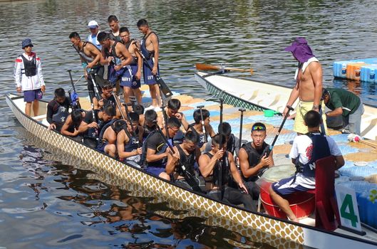 KAOHSIUNG, TAIWAN -- JUNE 10, 2018: A team of sailors from the navy prepares for the upcoming Dragon Boat Races.
