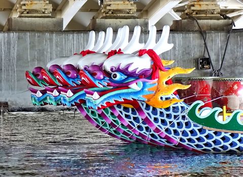 KAOHSIUNG, TAIWAN -- JUNE 10, 2018: A row of dragon boats with the traditional figureheads is being prepared for the upcoming Dragon Boat Festival.