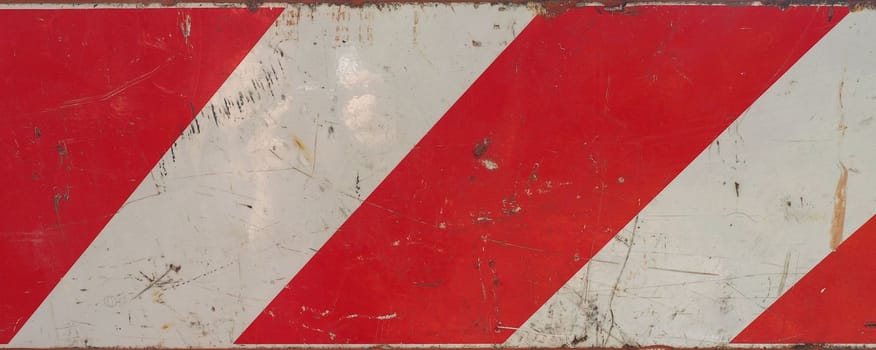 red and white striped metal traffic warning sign