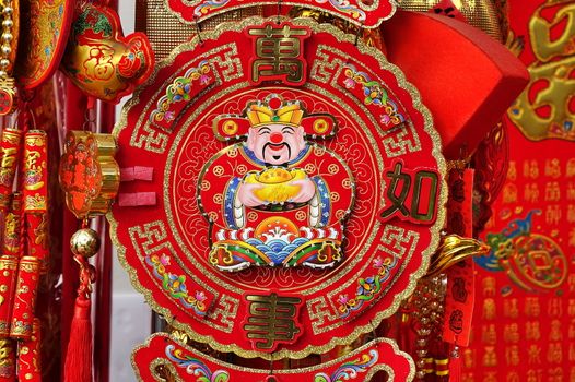 KAOHSIUNG, TAIWAN -- JANUARY 13, 2019: A store sells decorations for the Chinese New Year 2019. The image shows the God of Wealth and proverbs for good luck.
