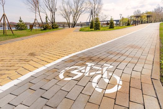 White bike path sign painted on a lane in the Natalka park of Kiev, Ukraine