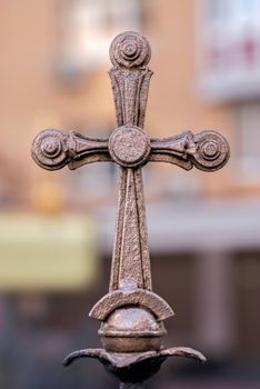 Bronze cross detail on a fence