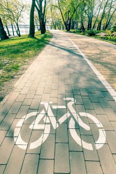 White bike path sign painted on a lane in the Natalka park of Kiev, Ukraine