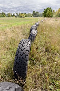 Old tires used to delineate the perimeter of a football field