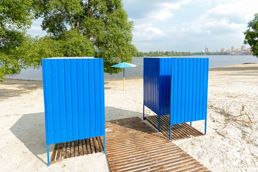 Blue metal wear changing cabins near on the sand beach near to the Dnieper river in Kiev