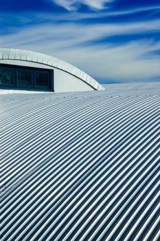 Metallic roof and blue sky with clouds