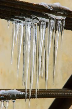 Water icicles dropping during the cold and gray winter