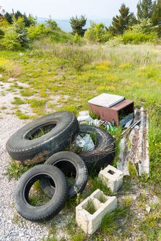 Old tires left in the Nature by disrespectful people, in the Italian countryside