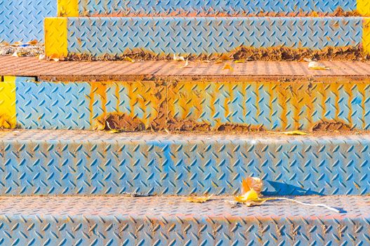 Old and rust metallic bleachers in an abandoned stadium