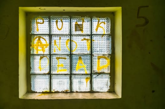 Glass block with "Punk not Dead" written on it