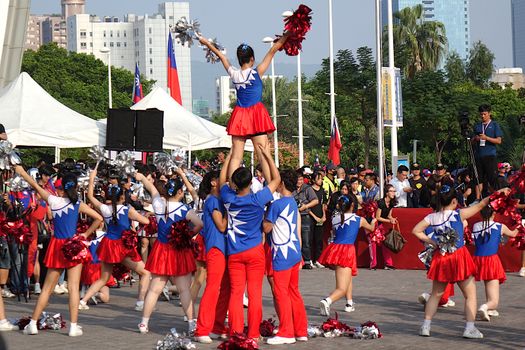 KAOHSIUNG, TAIWAN -- OCTOBER 10, 2019: Cheerleaders dressed in national flag colors perform as part of the national day celebrations at a free, public event. 
