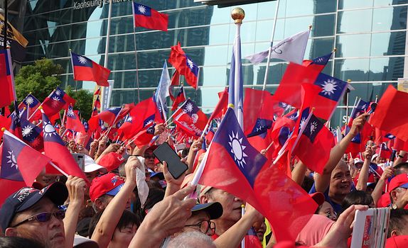 KAOHSIUNG, TAIWAN -- OCTOBER 10, 2019: An excited crowd waves national flags during the national day celebrations at a free, public event. 
