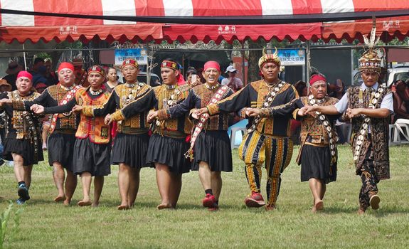 KAOHSIUNG, TAIWAN -- SEPTEMBER 28, 2019: Male members of the indigenous Rukai tribe perform a dance during the traditional harvest festival.
