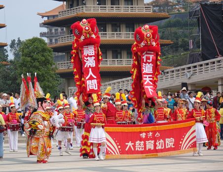 KAOHSIUNG, TAIWAN -- JANUARY 25, 2020: A parade at the Fo Guang Shan Buddhist complex during Chinese New Year. The Chinese characters mean "Da Zi Children's Home" and "Blessing for the New Year".