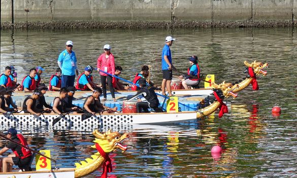 KAOHSIUNG, TAIWAN -- JUNE 7, 2019: Teams are positioning themselves at the starting line for the Love River dragon boat races.
