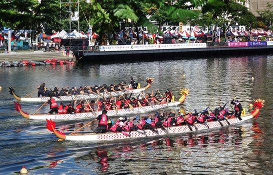 KAOHSIUNG, TAIWAN -- JUNE 7, 2019: Three teams compete in the Love River dragon boat races.
