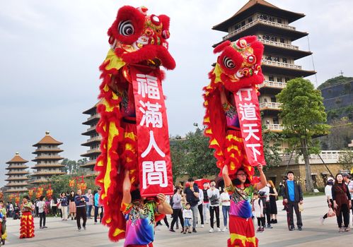 KAOHSIUNG, TAIWAN -- JANUARY 25, 2020: Traditional Chinese Lion dancers perform at the Fo Guang Shan Buddhist complex during Chinese New Year. The Chinese characters are a blessing for the New Year.