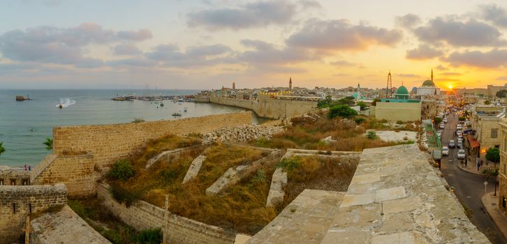 Panoramic sunset view with skyline, walls and fishing port, in the old city of Acre (Akko), Israel