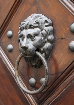 Lion head door knocker on a door in Prague