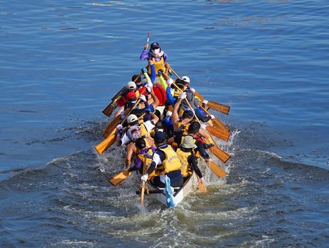KAOHSIUNG, TAIWAN -- JUNE 18, 2015: An unidentified team competes in the 2015 Dragon Boat Races on the Love River in Kaohsiung City.