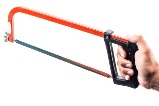 man who serves in his hand a rusty red hacksaw on a white background in studio