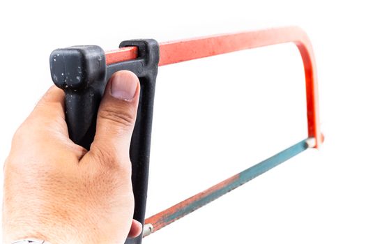 man who serves in his hand a rusty red hacksaw on a white background in studio