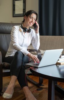 home session with natural light. Woman is smilling while talking on the phone