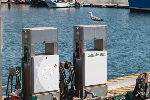 Setubal, Portugal - August 8, 2018: In the fishing harbor on a summer day, a gas station reserved to fishing boats