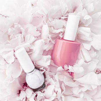 Nail polish bottles on floral background, french manicure and cosmetic branding design