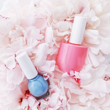 Nail polish bottles on floral background, french manicure and cosmetic branding design