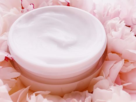 Face cream moisturizer on floral background as luxury skincare cosmetics, healthcare and beauty product concept