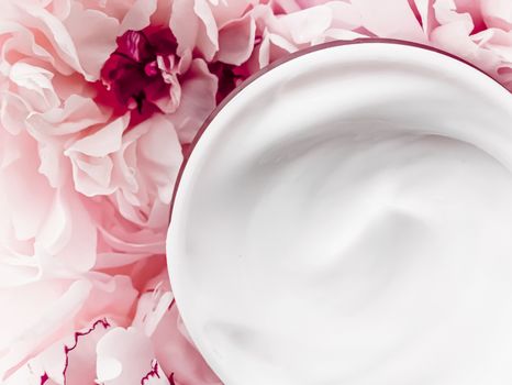 Face cream moisturizer on floral background as luxury skincare cosmetics, healthcare and beauty product concept