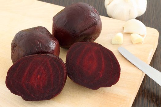 Cooked beetroot on wooden chopping board