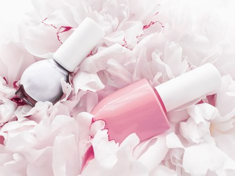 Nail polish bottles on floral background, french manicure and cosmetic branding design