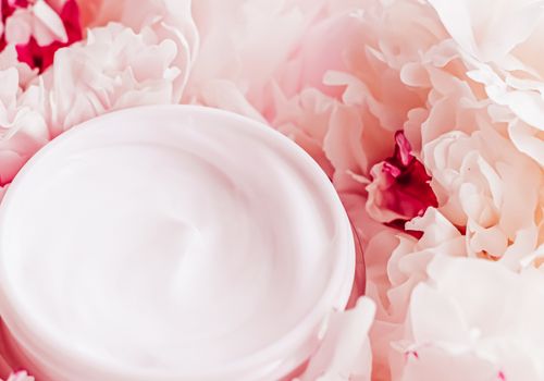 Luxe cosmetic cream jar as antiaging skincare routine product on background of peony flowers, body moisturizer and beauty branding design