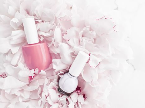 Nail polish bottles on floral background, french manicure and cosmetic branding design