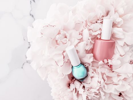 Nail polish bottles on floral background, french manicure and cosmetic branding design