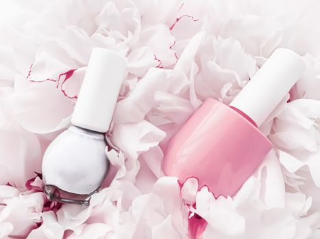 Nail polish bottles on floral background, french manicure and cosmetic branding design