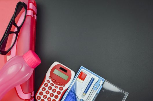 Various school supplies. studying, education and back to school concept. Black background and selective focus.