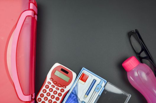 Various school supplies. studying, education and back to school concept. Black background and selective focus.